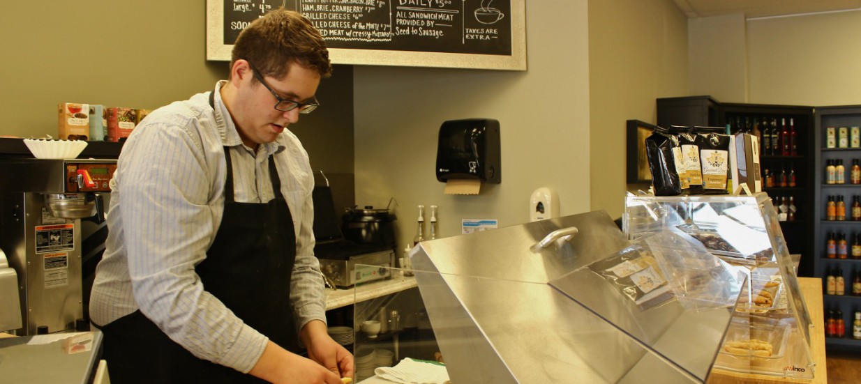 Jesse deWal constructs a deli sandwich at his shop, Gourmet Diem in Belleville, Ontario.