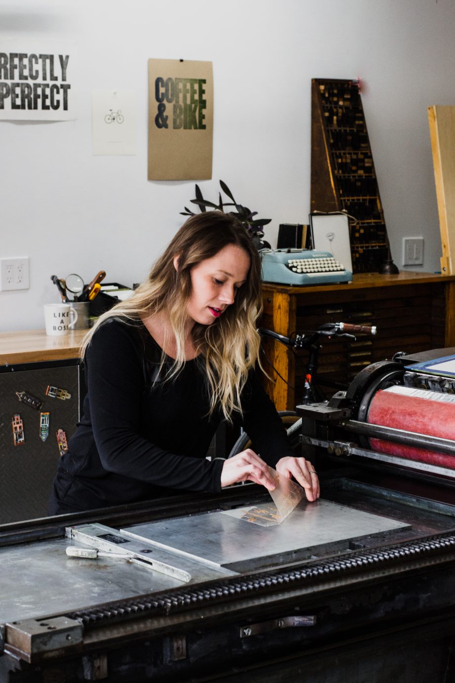 Amanda removes a polymer plate imprinted with one of her designs.