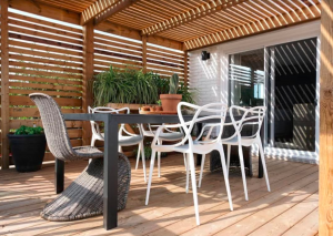 An outdoor living space with a dining area and pergola.