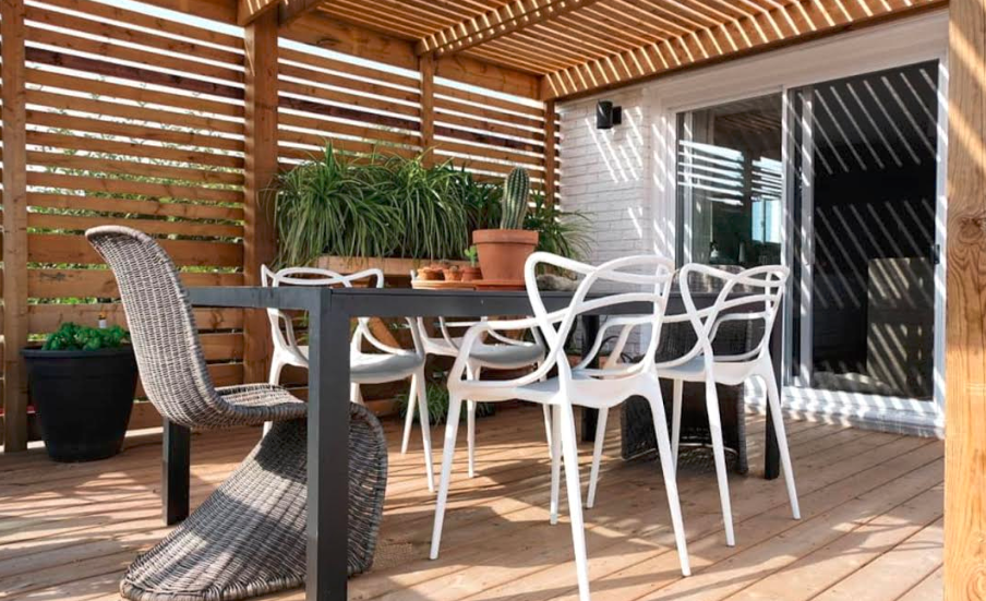 An outdoor living space with a dining area and pergola.