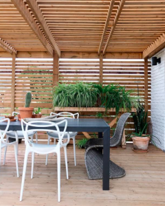 An outdoor living space with a dining area and pergola.