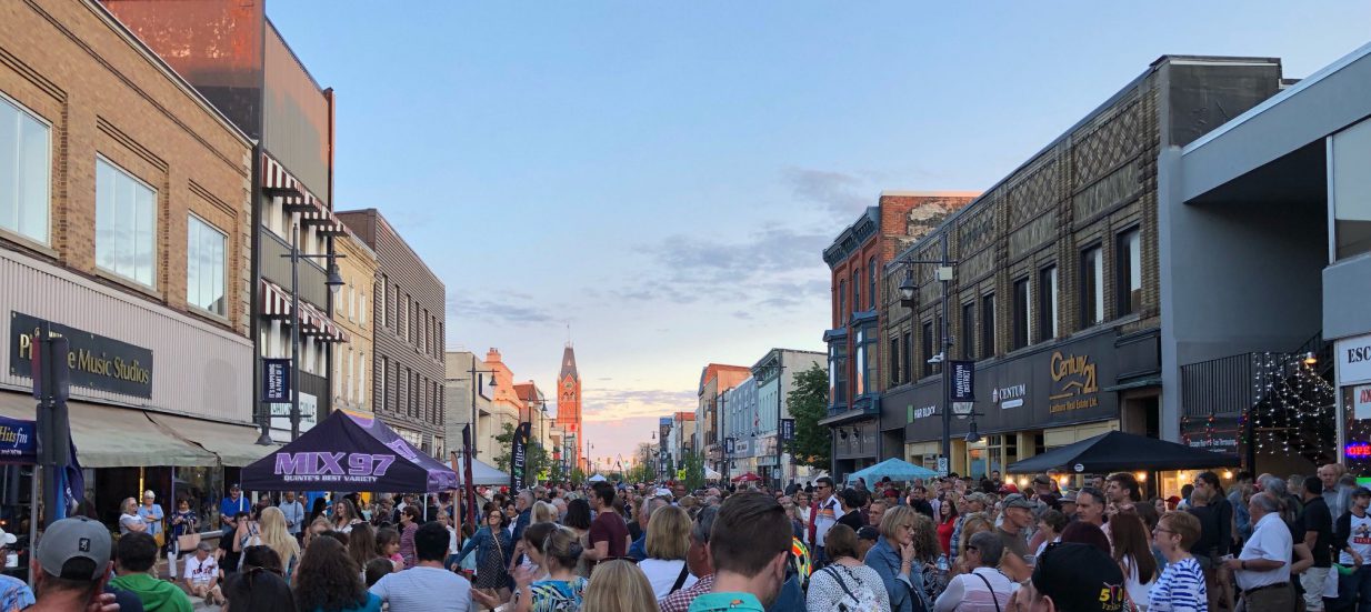 Crowd of people standing in the streets of downtown Belleville, Bay of Quinte