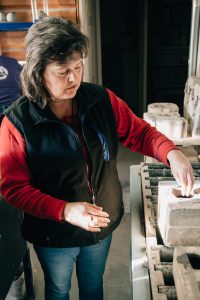 Marleen Murphy in her Millside Ceramics studio, explaining the process of filling the moulds.