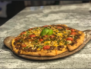 A pizza on a counter top.