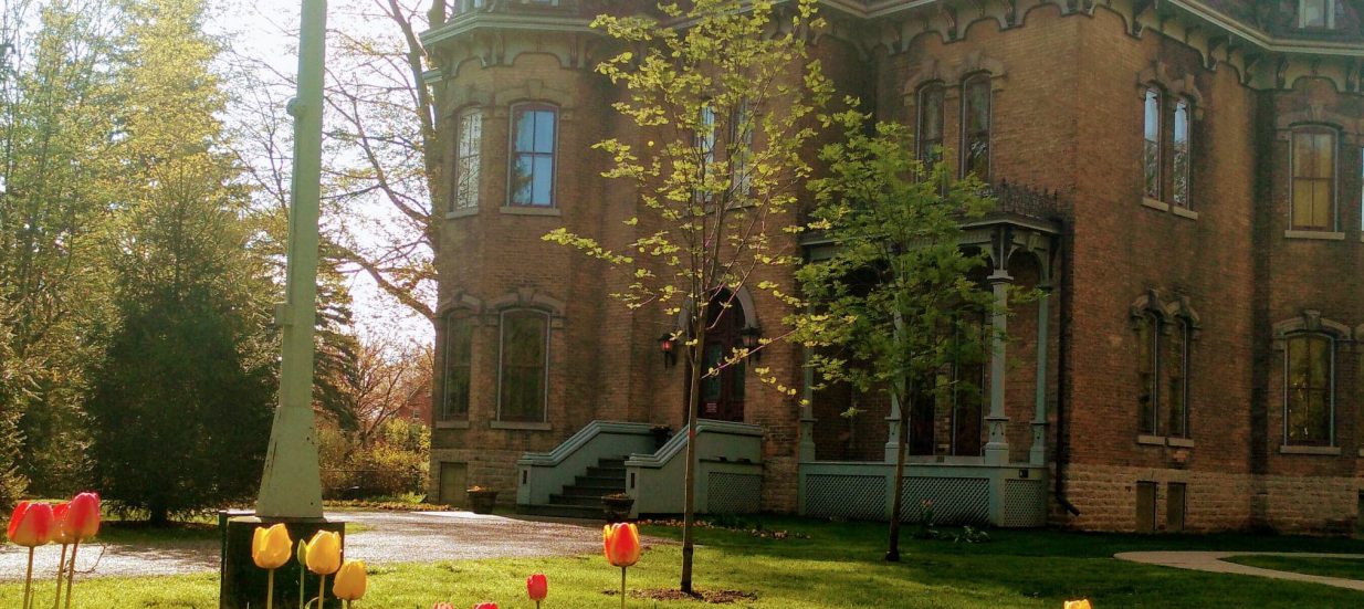 A photo of Glanmore, a Victorian mansion, with tulips in the garden.