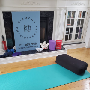 A turquoise yoga mat and block for physiotherapy.