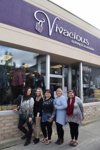 Women standing in front of a store.