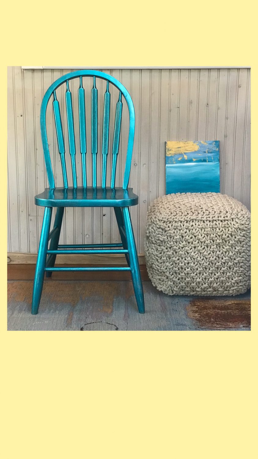 A blue chair next to a grey cushion.