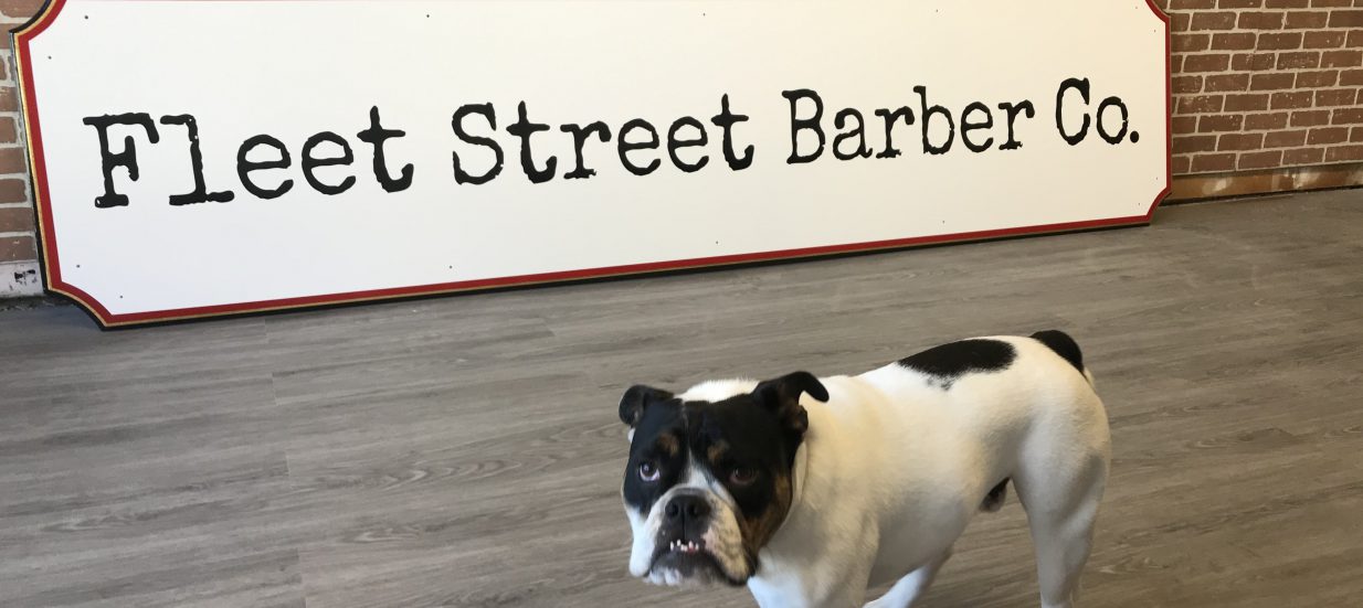 A dog in front of a sign that says, Fleet Street Barber Co. Peter Fletcher, owner of Fleet Street Barber Co in downtown Trenton, shares what it's been like adapting to the challenges of the pandemic.