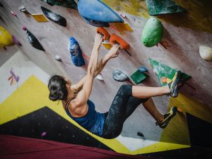 Female rock climbing indoors