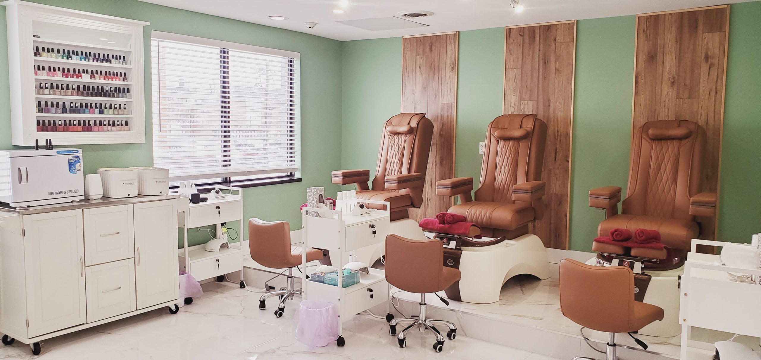 Pedicure chairs at a spa in a bright room.