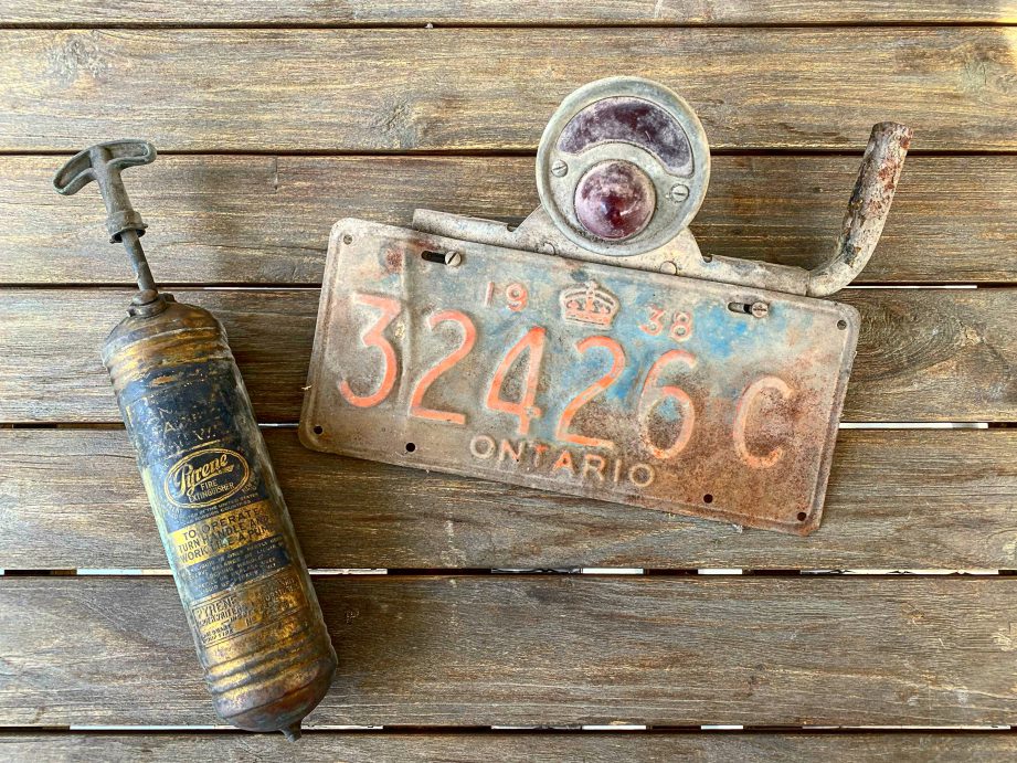 An old licence plate on a wooden table.