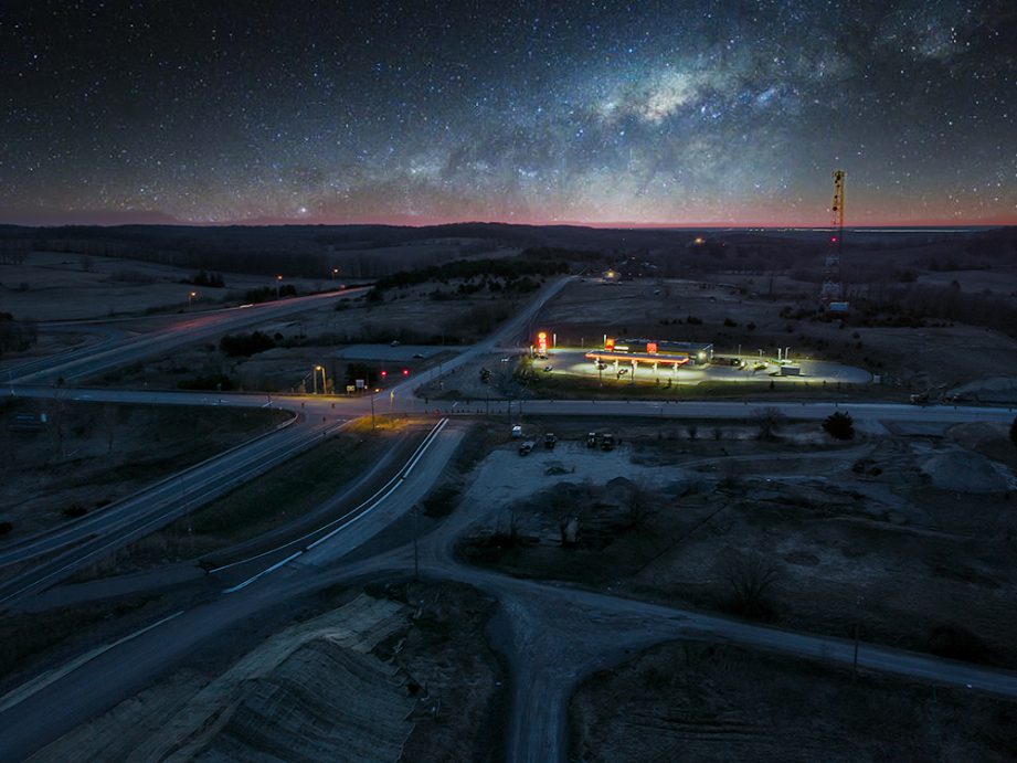 Aerial photo of highway roads and construction with a starry night.