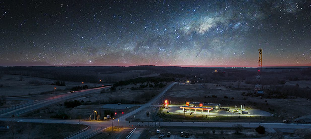 Aerial photo of highway roads and construction with a starry night.