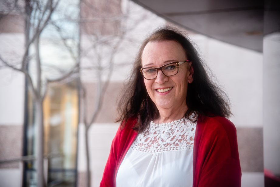 A person wearing a white shirt and red sweater smiling. A new non-profit, SAGA-LGBTQ Education and Support Services of Canada, aims to supporting the LGBTQ2S+ community in the Bay of Quinte region.