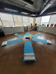 Yoga mats are set out in She's High on Vibes' studio for a meditation session.